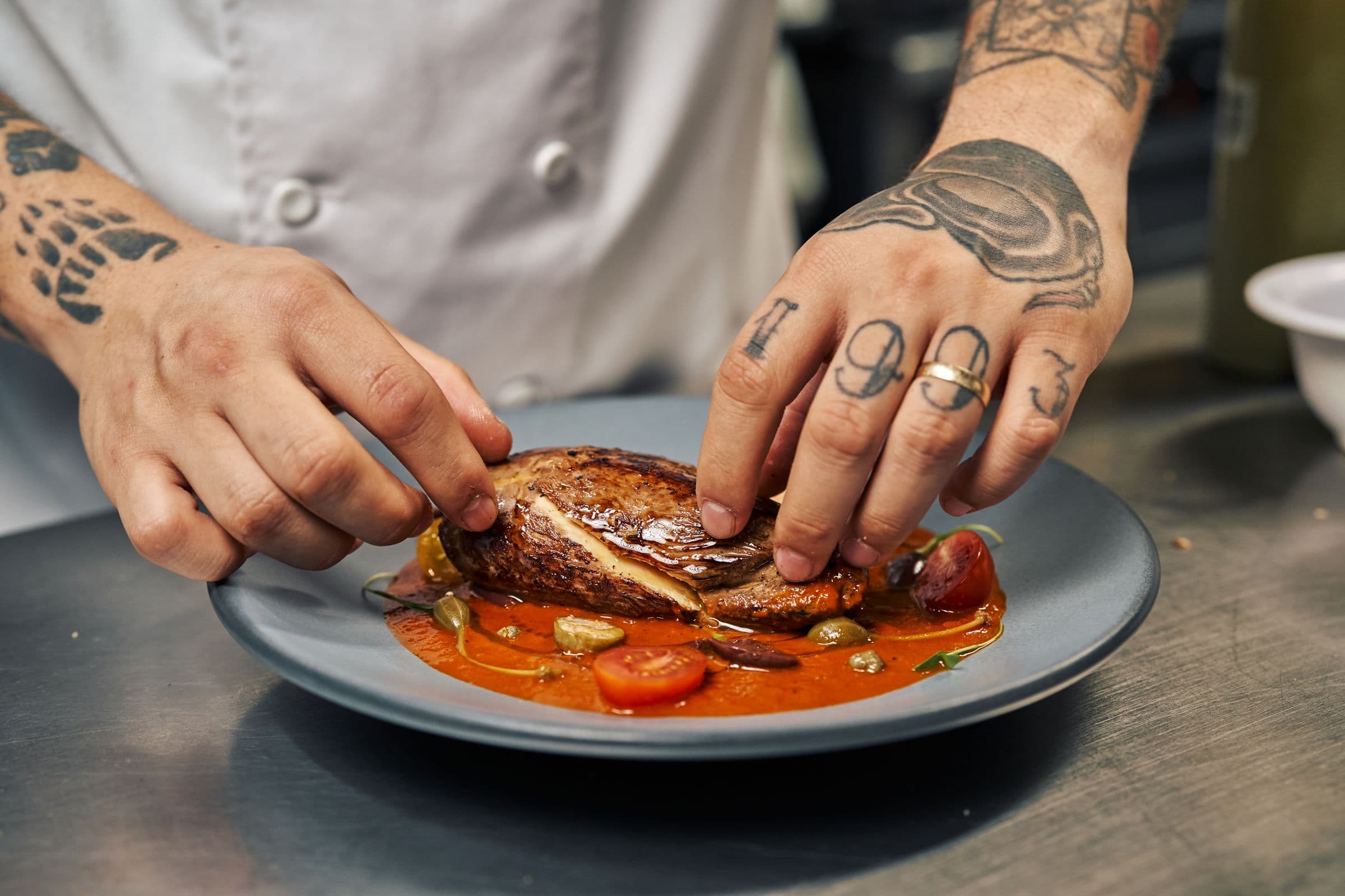 A chef working the line on the kitchen pass during service